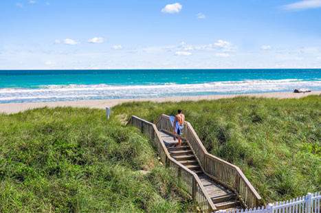 Steps to a boardwalk that leads to the beach